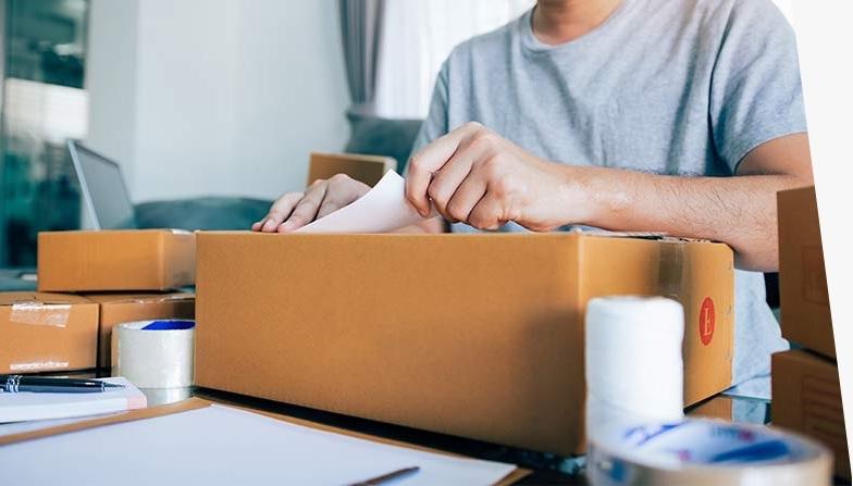 Person preparing to send a package using First-Class Package International service.